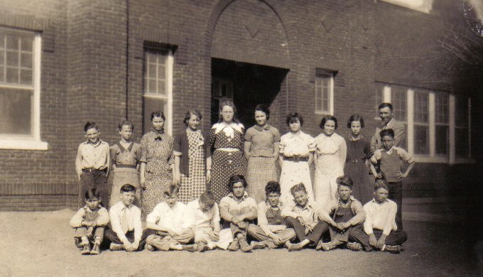 Sun City School Students, Barber County, Kansas.

Back Row: Harold Hoss, Ellen Tuefel, Juanita Williams, Jessie Alsbrugh, Sonora Lee Ward, Euva Huse, Crola Mae Rogers, Helen Ward, Bonnie Freeman, Mr. James Stranathan, Billy Howard Martin.

Front Row: Marlin Kramer, Meade Adams, J.R.Massey, Mark McLain, Harold Urton, Marion Hastings, Harold Walker, Wesley Urton, Phil Davis.

Photo courtesy of Kim Fowles. Photo caption courtesy of David Massey.