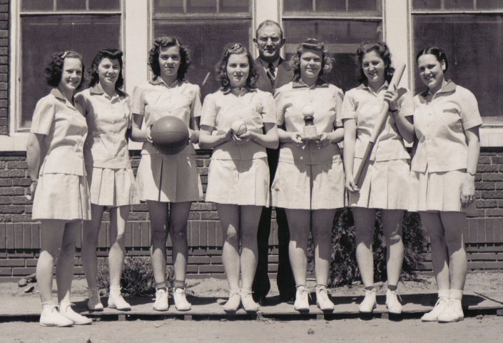 Sun City Girls Basketball Team, 1940-41, Sun City, Barber County, Kansas.

Left to right: Grace Mae Smelser, Ethelda Winnop, Emma Ellen Keller, Evah Mary Larkin, Robert Ann Froman, Minnie Lee Massey, Helen Ward. In back: Coach C.R. McDougal.

Photo courtesy of Brenda McLain.

CLICK HERE to view larger image.