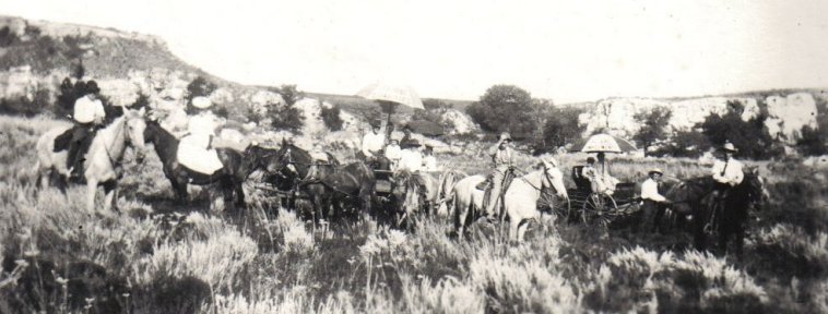 A group of people dressed in their 'Sunday Best' on horses and in buggies in the countryside..

Photo courtesy of Rhonda (Cline) Nickel.