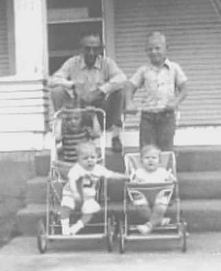 This photo is of Wilna Cobb, my cousins Darold and Kenneth Davis, Thad (Wilna's grandson (although we don�t know who he belongs to!) and me.  It was taken at my grandparents farmhouse located 10 miles south of Greensburg.  I'd guess by looking that it was taken around 1952 or 1953, since I'm in a stroller!  Darold and Kenneth are the two oldest sons of my dad�s sister, Marjorie, who married Dale Davis of Greensburg on May 6, 1994.  Besides the two sons mentioned, they have one other son, Robert. - quoted from Nancy Smith.