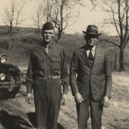 Pvt. Delmer Lee 'Buck' Ferrin, U.S. Army,  with his father, Ernest Leroy Ferrin, at the Ferrin farm, West Powell Township, Comanche County, Kansas, about 1944.  This photo was taken by Wendel Ferrin of this brother and father just before Delmer left for WWII service in Europe.