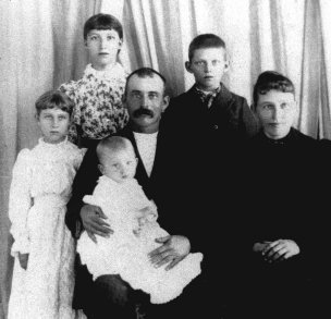 Loren & Alcana (Wagner) Ferrin with their children: from left, Nellie, Maude and Ernest. Loren holds Walter. West Powell Township, Comanche County, Ks, circa 1895.