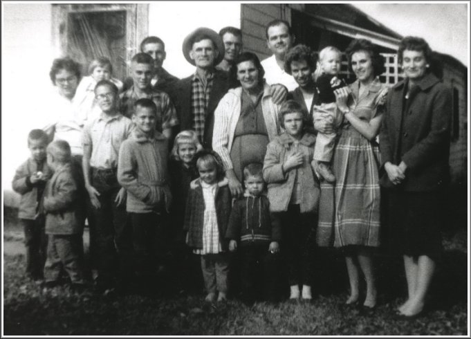 Back row, from left: Karen Jo (Hopkins) Norton holding Mitzi Norton, Darrell Ferrin (in plaid shirt), Donald Norton (behind Darrell), Robert Emmett Norton, E.L. Ashlock, Gladys Leota (Grauberger) Norton, Jim Hudson, Betty (Lacey) Hudson nee Norton, Billy Bob Norton being held by Wanda Leota (Norton) Ashlock, Alice Lorene (Norton) Ferrin. Front row, from left: Randy Norton, Greg Norton, Jerry Ferrin, Brent Ferrin, Janet Ferrin, Christa Ashlock, ______ Hudson, Debbie Norton. Photo by Wendel Ferrin, circa 1960, Protection, Kansas.