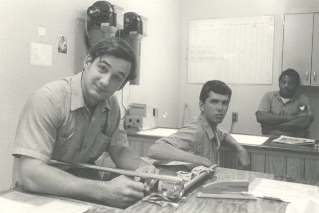 PHAN Pat Sweeney, PH3 Robin Tedder and PH2 Frank Devance, US Navy Photographers, in the Still Photo Lab, National Parachute Test Range, El Centro, CA, circa 1975.  

Photo by PHAN Jerry Ferrin.