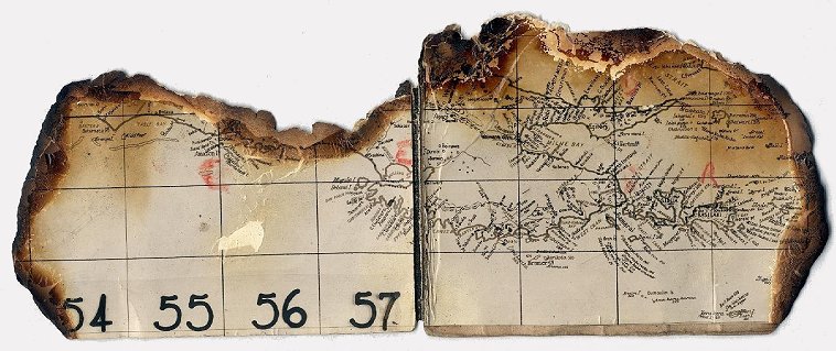 'Air map of a P.38 - which was shot down by Zero in Dog fight. The pilot was killed and plane burned. February 1943'.  

Pictured is a piece of the bottom border of a map showing the southeast tip of Papua, New Guinea measuring about 9 inches x 3 inches,  burned on the edges. 

Collection of Paul Roales, used with his permission.