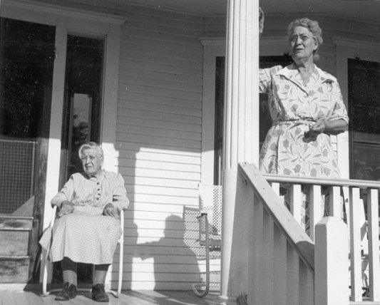 Alcana (Wagner) Ferrin and her daughter, Maude (Ferrin) Watkins, on the front porch of their home in Wilmore, Comanche County, Ks.  Photo by John Edward Schrock.