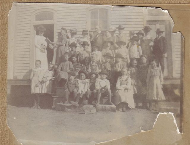 Sun City School, 1901, Barber County, Kansas. 

Teacher - middle back row - Lloyd Davis.

First Row - 2nd from left - Lyle Bullock.

First Row - 4th from left - no shoes - Cliff Hoagland, great grandfather of Kim (Hoagland) Fowles.

2nd row:  girl standing - far left - Edith F. Hoagland (later married Waldo Leffler).

2nd row:  first girl sitting far left:  Nina Pansy Hoagland.

From Elloise Leffler's photo collection, courtesy of Kim Fowles