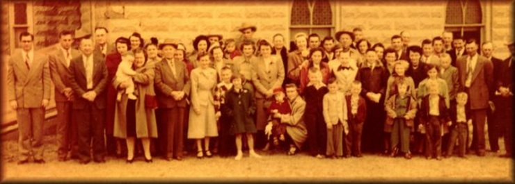 The congregation of the Wilmore Church of Christ, Wilmore, Comanche County, Ks, July 1952. Photo from the collection of Wendel Ferrin, who is the tall man in the center of the back row. Weldon Trummel is the second person from the left and 'Slim' Masterson is the 4th man from left.