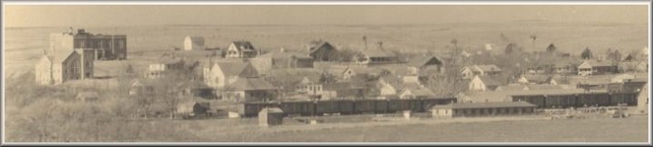 Aerial view of Wilmore, Comanche County, Ks.  The large brick building at left is now the Federated Church; behind it is the  Wilmore High School.  Photo copyright John Edward Schrock 1950