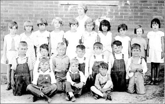 Wilmore Grade School, 1st & 2nd Grade Class - 1931.Teacher:  Ms. Kernahan. Back row:  Helen Alder, Elvy Hall, Frances Carter, Jean Snyder, Betty Suiter?, Rosemary Boles, Myrtle Faucett, Aleane Ray, Georg Ellen Metzger, Evaugn Smith. Second Row:  Harold Woods, Richard Hackney, Gene Harp, Gene Herd, Glenn Metzger, Ernest Lawrence.  Front Row:  Wesley Smith, Robert Shereck, Jimmy Booth, Paul Ward.