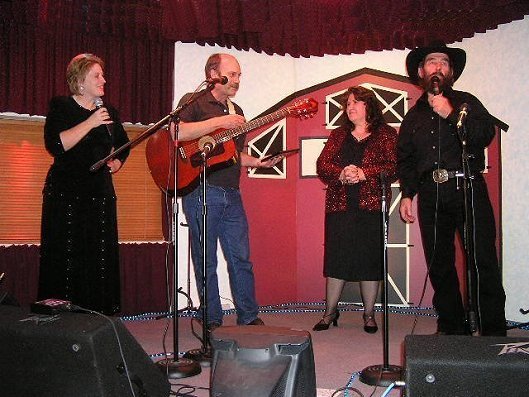 Presentation of a plaque of appreciation to Jerry Ferrin at the 6 Nov 2004 Wilmore Opry. From left: Vanita Blundell, Jerry Ferrin, Linda Winter and Dan Winter.

Photo courtesy of Dave Rose.