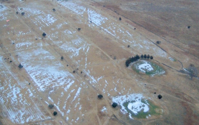 Crown Hill Cemetery near Coldwater, Comanche County, Kansas. Aerial photograph of the cemetery with a dusting of snow in late 2007. 

Note the ruts of the old road from Wilmore to Coldwater which run through the cemetery. 

Photo by Richard L. 'Rick' Beeley.