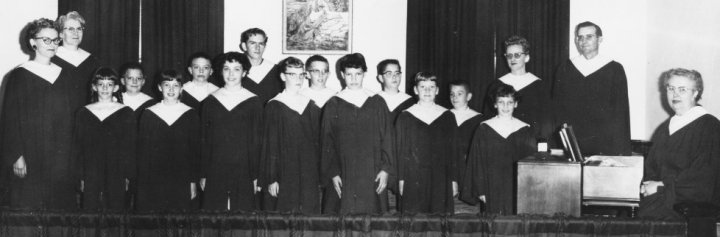 The Wilmore Baptist Church Choir sporting their new robes in 1959.

Front row:  Ruby Booth, Lonna Lawrence, VanVranken (daughter), Guyneth Timmer, Nancy Metzger, Diana Weddel, Mary Jane Metzger, Norma York and Frances Ridge at the organ.

Back row: Hazel Boley, David Lawrence, Larry Lawrence, Jimmy Clayton, Kenneth Timmer, VanVranken (last name), Mike York, Kathy York and Pastor Ernest Lawrence.