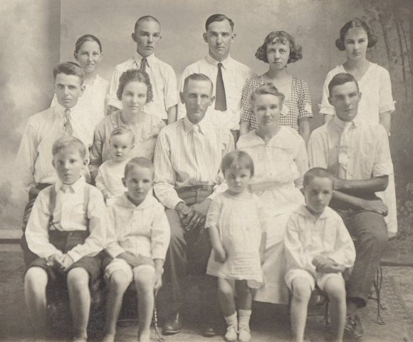 J.M. and Minerva Cline family, circa 1920.
 
Back:  Frances, Allen, Hueston, Hueston's wife Jess, Edith.
 
Middle:  Leta's husband Edson Thompson, Leta Thompson (holding Marguerite), J.M. Cline, Minerva Cline, Kenneth.
 
Front:  LeeRoy, Raymond, Jessie, Junior (J.R.).

Photo courtesy of Rhonda (Cline) Nickel.