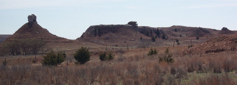 Deubler's Mound, aka Parker's Mound, Comanche County, Kansas.

'This picture shows the fence between the Merrill ranch pasture and the 'Deubler' pasture. The 'split rock' formation on the mound is a prominent landmark in the area. We call it Deubler's Mound or Parker's Mound.'

Photo taken by Phyllis Scherich, 30 March 2003.