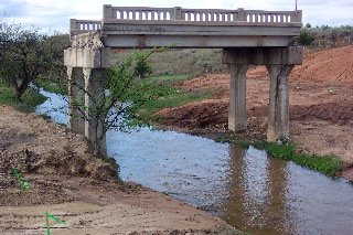 The last remaining portion of the old Mule Creek Bridge on Highway 160, 27 April 2004.  Photo by Phyllis Scherich.