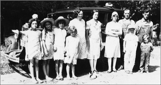 The Sam Lawrence family with friends, 1928. Sam is at the far right with his son, Ernest, standing in front of him.