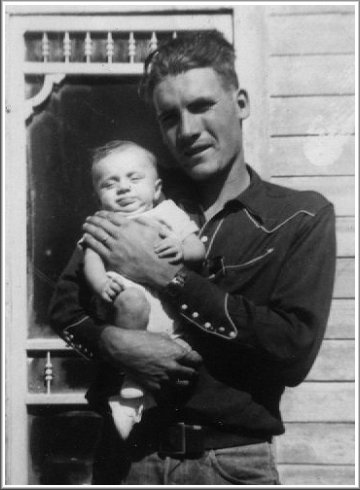 Bill Norton holding Darrell Ferrin at the Norton's house in Protection, Kansas, late 1950. Photo from the collection of Alice (Norton) Ferrin.