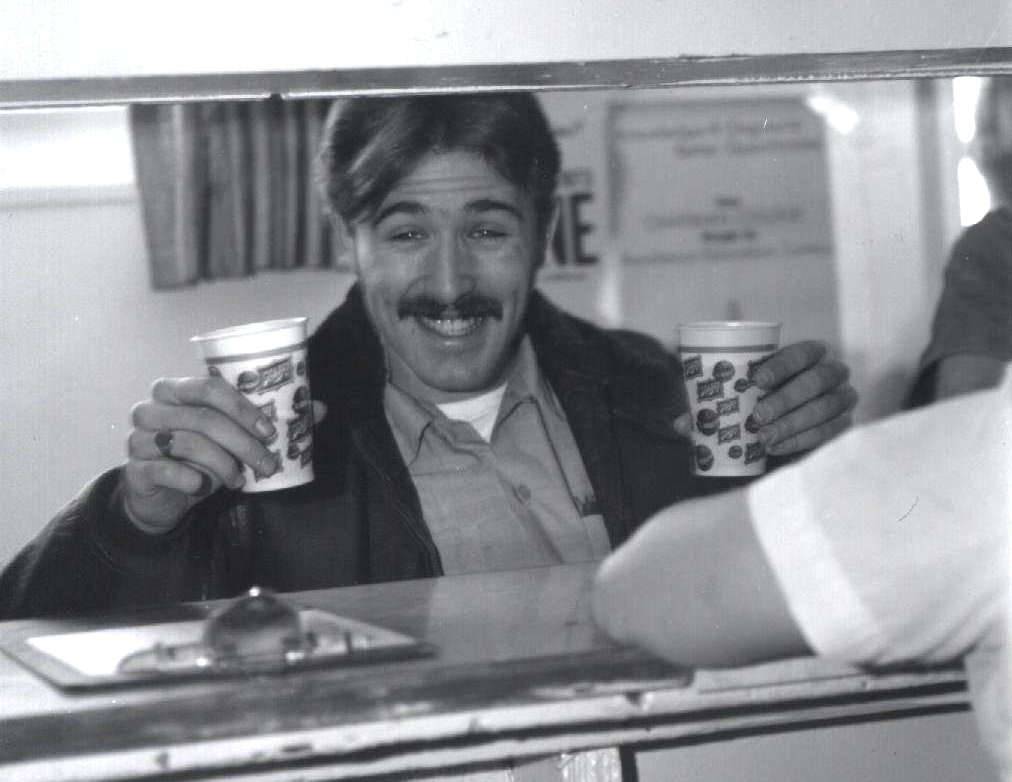 PHAN Scott McDonald with two glasses of beer, seen from inside the sign-in window of the Enlisted chow hall at the National Parachute Test Range, El Centro, California, circa 1975.

Photo by PHAN Pat 'Smitty' Smith.