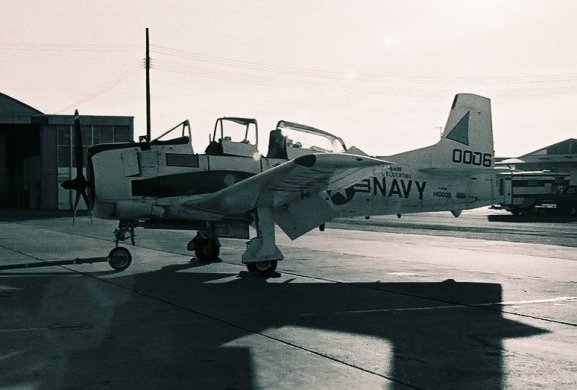 NPTR T-28B Trojan, BuNo 140006, on the flight line.

National Parachute Test Range, El Centro, California, circa 1975.

Photo by PHAN Pat 'Smitty' Smith.

CLICK HERE to view a larger, uncropped copy of this image in a new browser window.