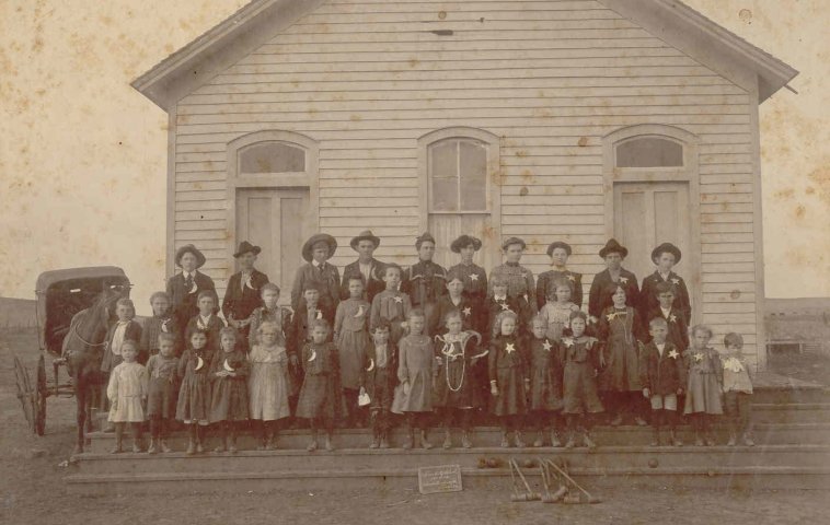 Sun City School, 1903 - 1904, Barber County, Kansas.

Bernice Woodard, Teacher: 6th person from right on back row.
 
Lyle Bullock, holding horse - far left - 2nd row.

Nina Hoagland - 2nd row - 6th from the left.

Edith F. Hoagland - 2nd row - 7th from the left. 

From Elloise Leffler's photo collection, courtesy of Kim Fowles.

CLICK HERE to view larger image.