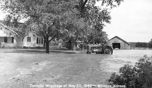 Wendel Ferrin on his tractor on a flooded street in  Wilmore, Comanche County, Kansas, while helping to clean up damage from the tornado which hit the town on May 20, 1949. Photo by John Edward (Ed) Schrock, used with permission of Janet Schrock Hubbard.