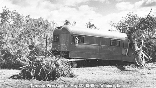 A train car damaged by falling trees in the May 20, 1949, tornado which hit Wilmore, Comanche County, Kansas. Photo by John Edward (Ed) Schrock, used with permission of Janet Schrock Hubbard.