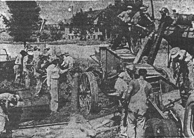 Pictured here is a group of Coldwater business men junking an old combine and two tractors on the B. J. Herd used machinery lot on Junk Rally Day, August 28, 1942.  Every place of business in the county closed that day and everyone stopped work for an all-out drive.