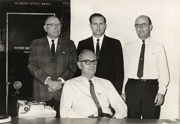 Wilmore Bank staff, 1968:
 
(Left to right) F. H. Moberley, Lester Fry, Jr., Walter Smith. Seated: Myrl Dellinger. Wilmore, , Comanche County, Kansas.

Photo courtesy of Nancy Smith.