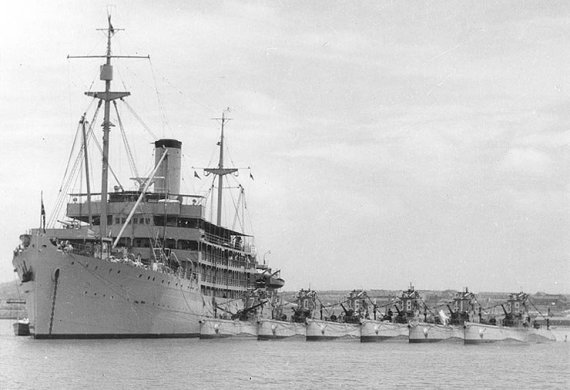 USS Canopus (AS-9), with the Asiatic Fleet's Submarine Squadron Five alongside, during the 1930s. 

The submarines present include (from left to right): S-37 (SS-142); S-40 (SS-145); S-36 (SS-141); S-38 (SS-143); S-41 (SS-146); S-39 (SS-144).

US National Archives photo # 80-G-1014615, a US Navy Photograph, now in the collections of the National Archives.